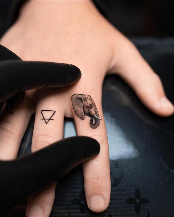 Miniature tattoo of a realistic elephant on the finger