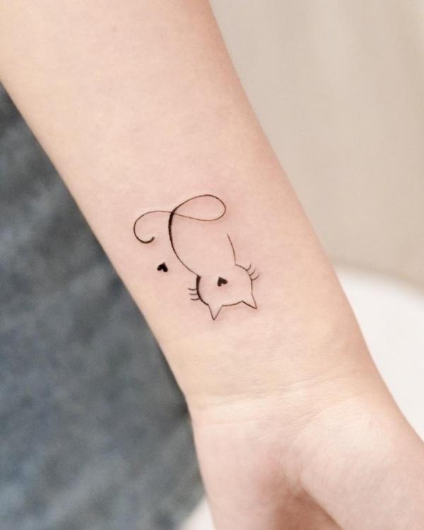 Ink of minimalist inverted cat with two hearts
