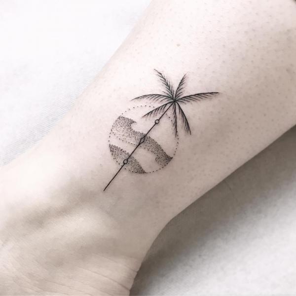 Minimalist tattoo of coconut tree on the beach