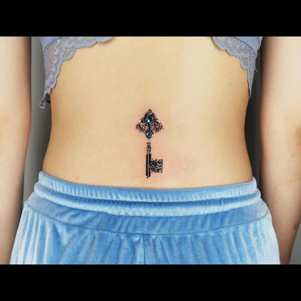 Sophisticated Key tattoo with gems and valuable stones on the low back