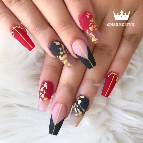 Black and crimson fingernails with metallic embellishments 