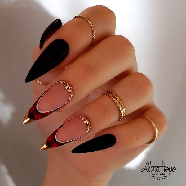 The manicure that features a black and red plaid pattern on the tips of the nails, with a metallic tip to add a bit of shine and glamour
