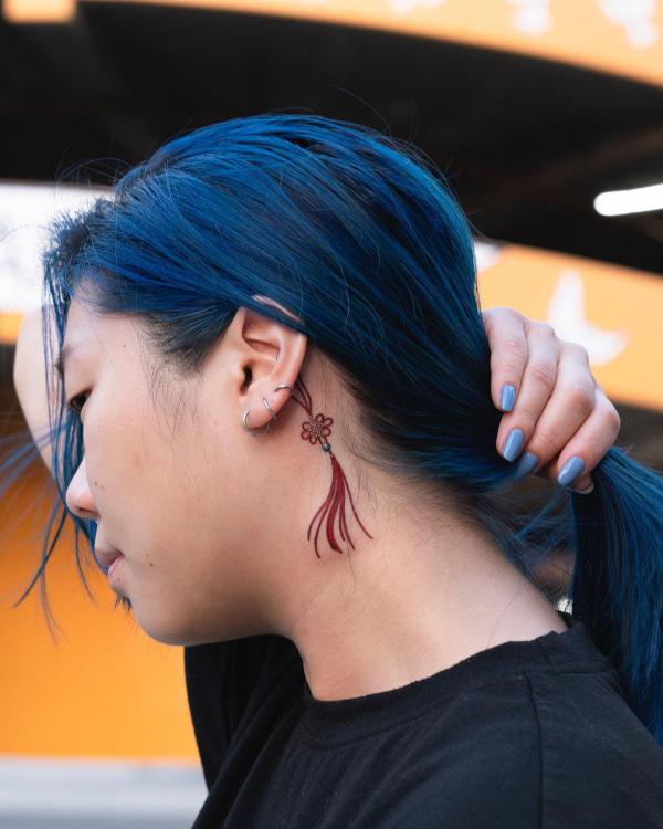 Small knots and tassel with a blue bead behind the ear 1