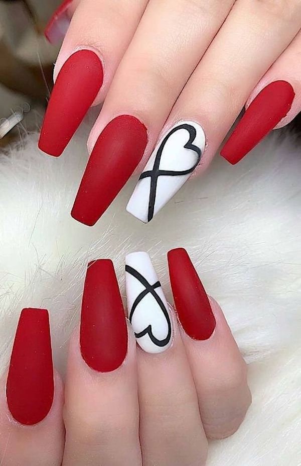  The nails for Valentine's Day. The middle finger's white nail bed has a stylish heart outline, and the rest of the nails are painted in a coffin shape with pure crimson. Showing of mature love.