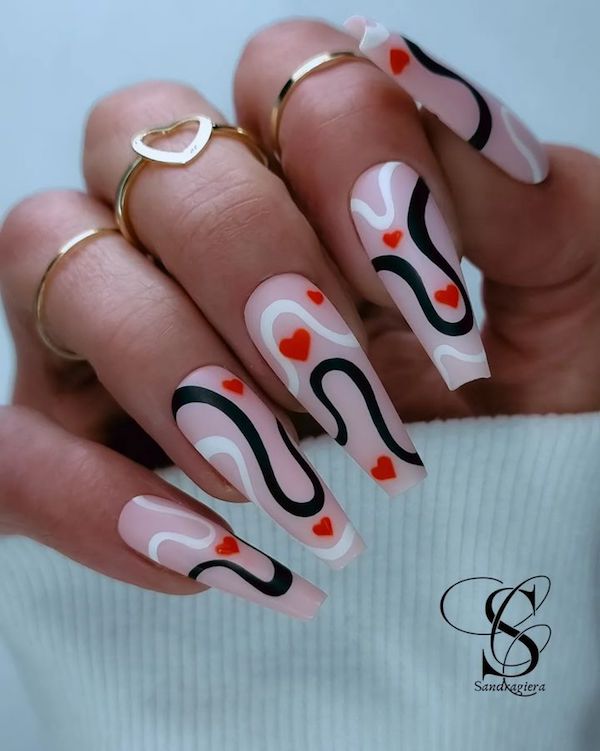 Valentines coffin nail art - Red hearts on pink nail beds accompanied by abstract wave designs 