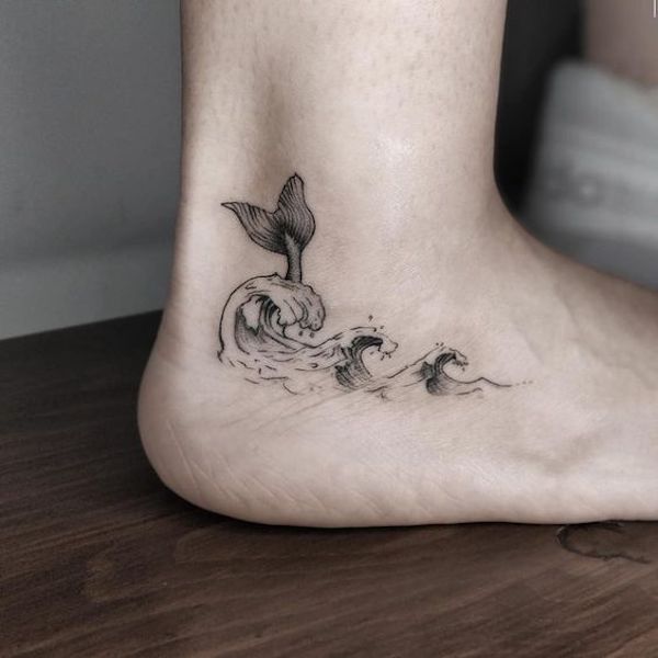 Ankle tattoo with wave and whales tail