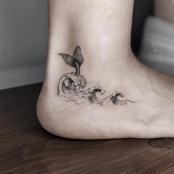 Ankle tattoo with wave and whales tail Ankle tattoo with wave and whales tail
