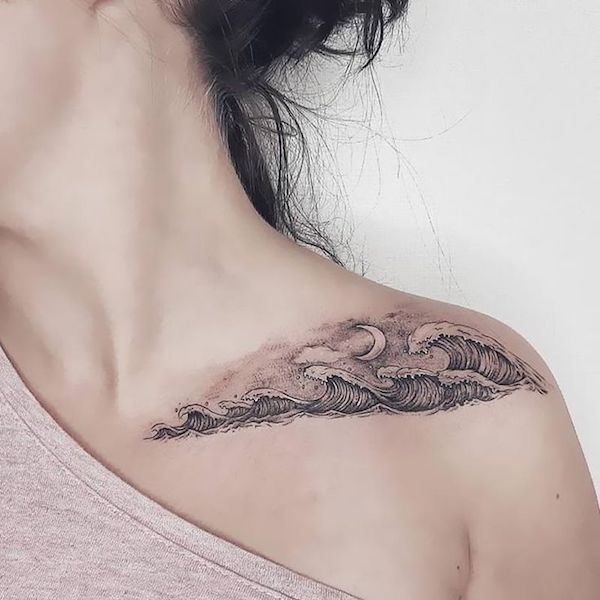 Black and gray waves shoulder tattoo female