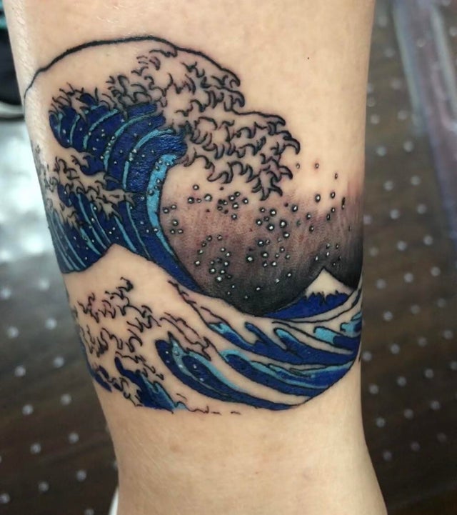 Great wave tattoo with water droplets