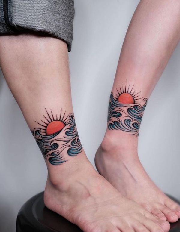Matching tattoos with waves and sun