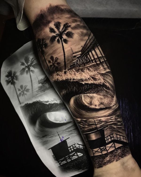 Realistic forearm tattoo with waves bridge and shoreline.