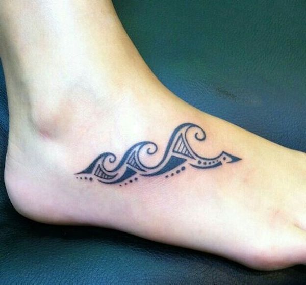 Tattoo of a tiny foot wave in tribal design