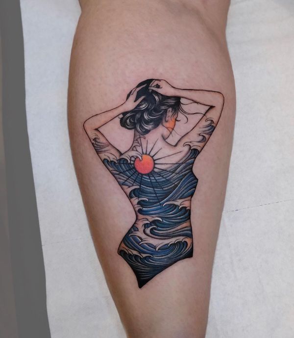 Tattooed woman with wave around her body
