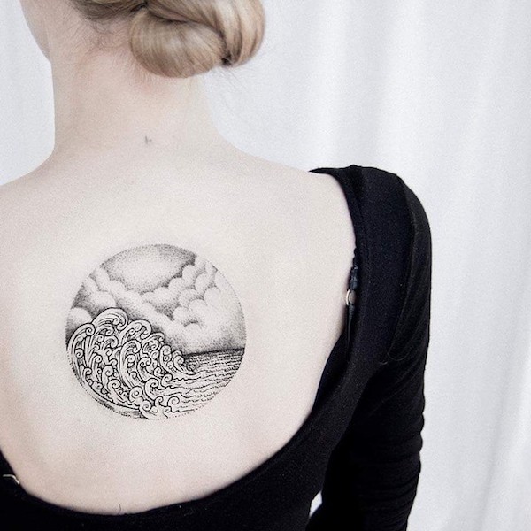 Wave and cloud back tattoo for women