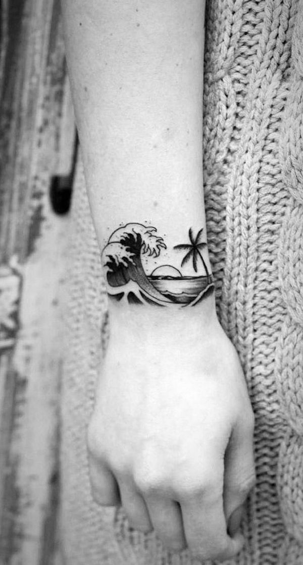 Wrist tattoo with sun wave and beach