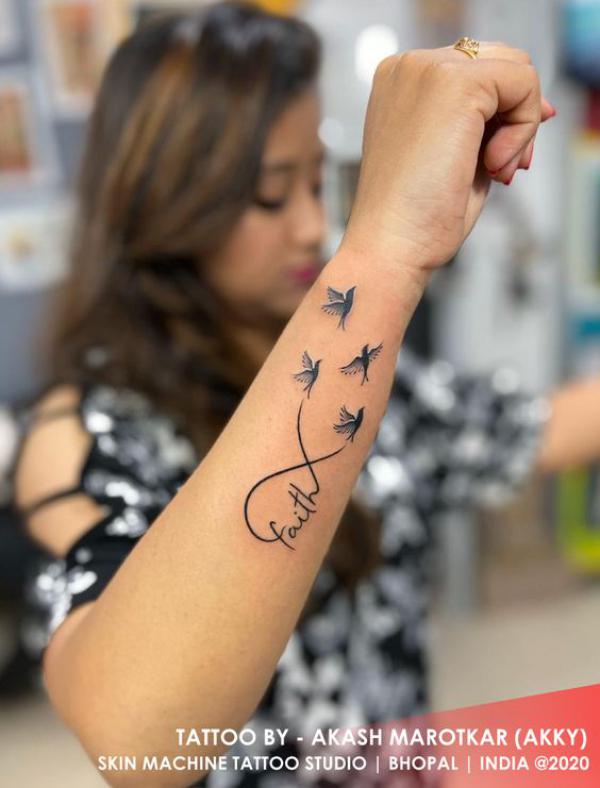 Faith infinity with birds tattoo