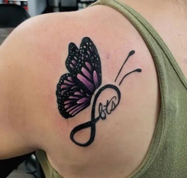 Infinity symbol and butterfly shoulder blade tattoo