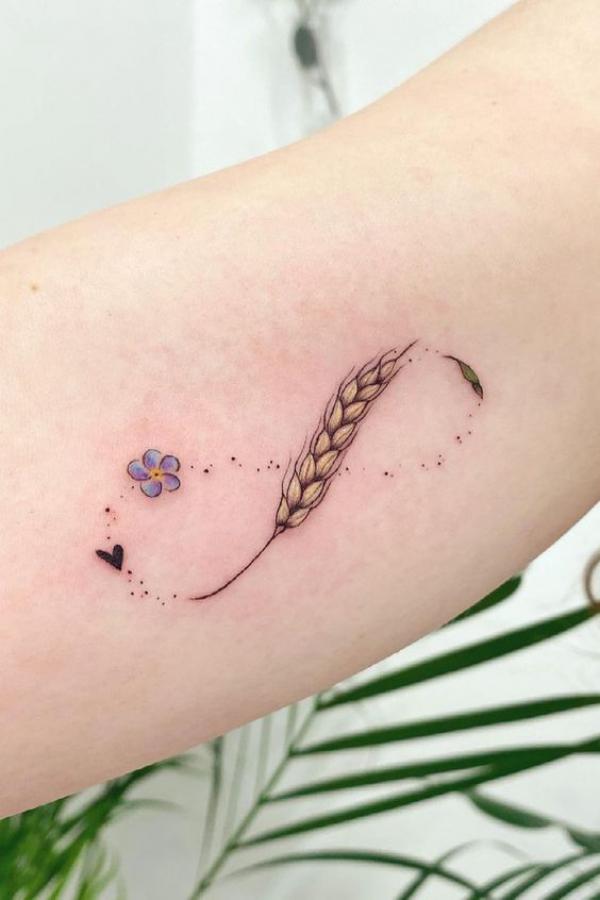 Infinity tattoo with flower and ears of wheat in Yin Yang style