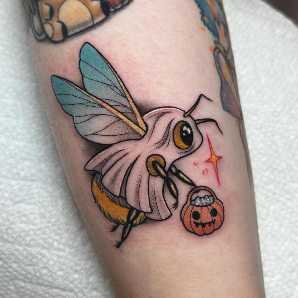 A boo bee holding a pumpkin