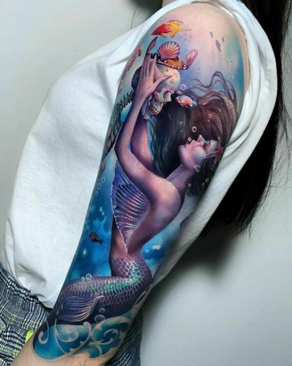 A mermaid holding a skull tattoo
