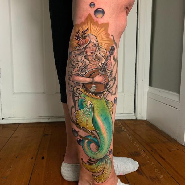 A mermaid playing music instrument