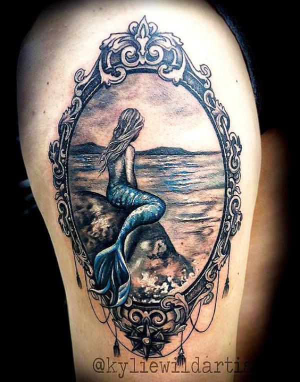 A mermaid sitting at shore picture frame tattoo