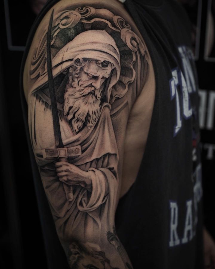 A priest holding sword half sleeve tattoo