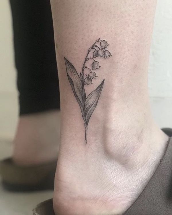 Black and gray lily of the valley on the back of the ankle