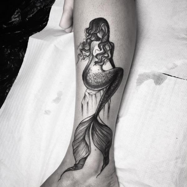 Black and grey mermaid lower leg tattoo