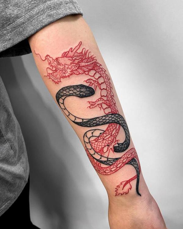 Black snake and red dragon tattoo on forearm