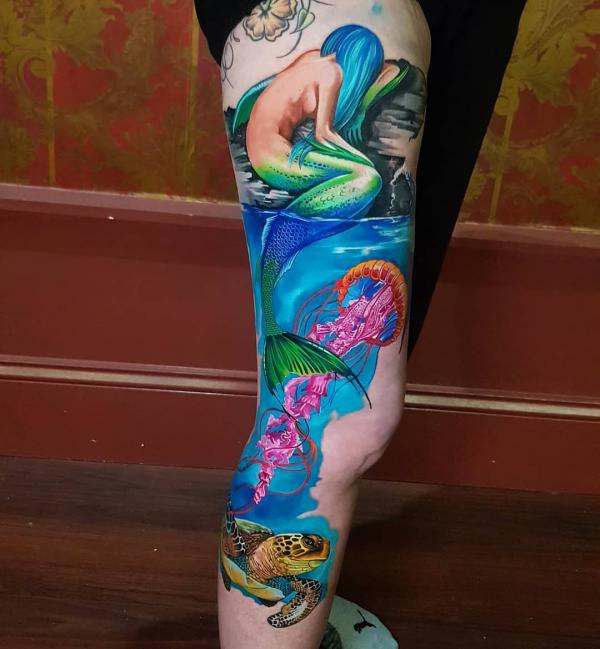 Colorful mermaid jellyfish sea turtle leg tattoo