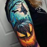 Colorful pumpkin tattoo with flying bats