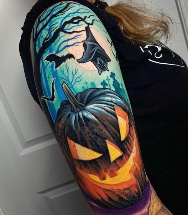 Colorful pumpkin tattoo with flying bats