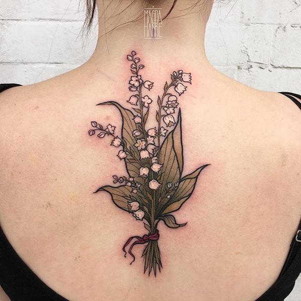 Elegant lily of the valley back tattoo
