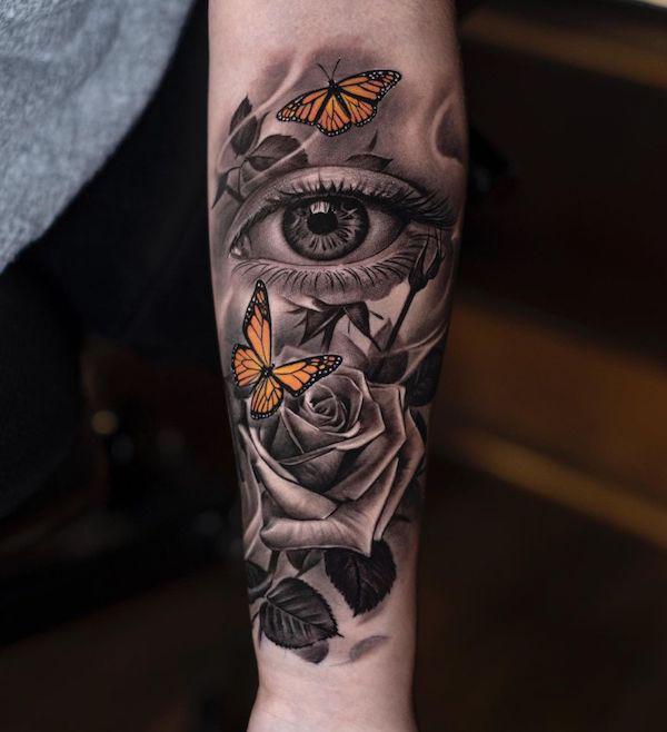Eye tattoo with butterflies and rose