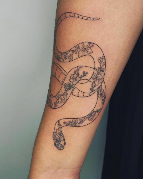 Floral snake forearm tattoo