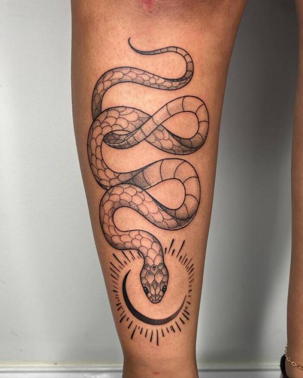 Geometric snake and sun with halo tattoo