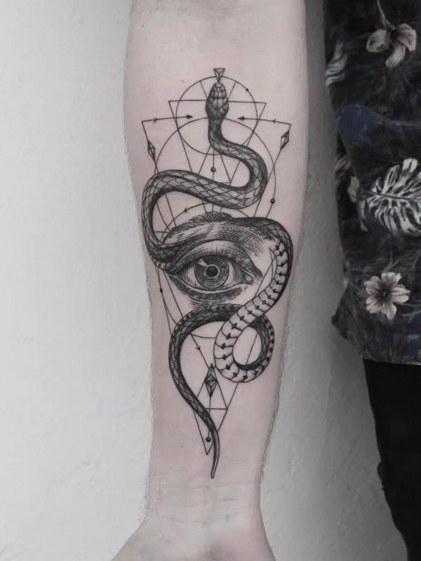 Geometric snake with eye tattoo on forearm