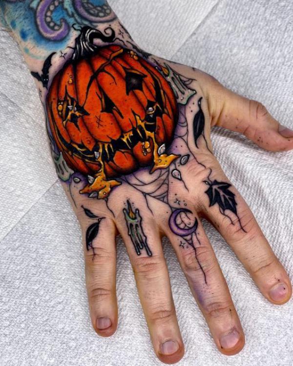 Halloween pumpkin hand tattoo