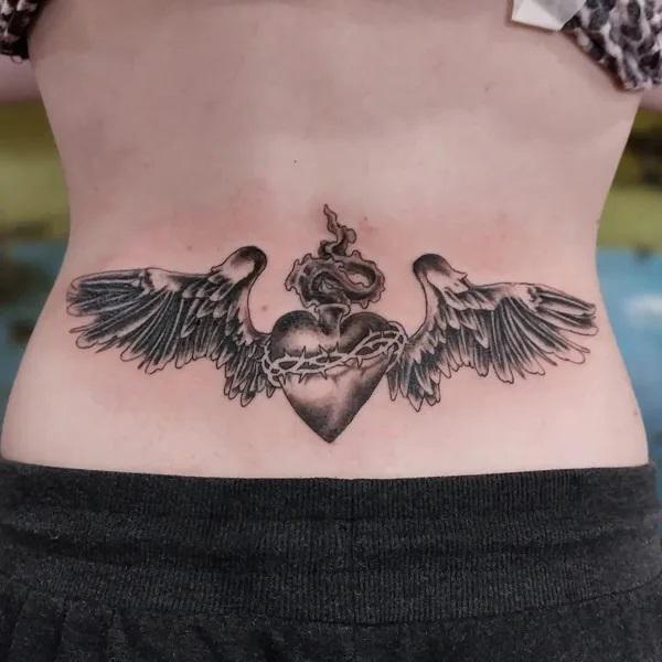 Low back Sacred heart with wings tattoo