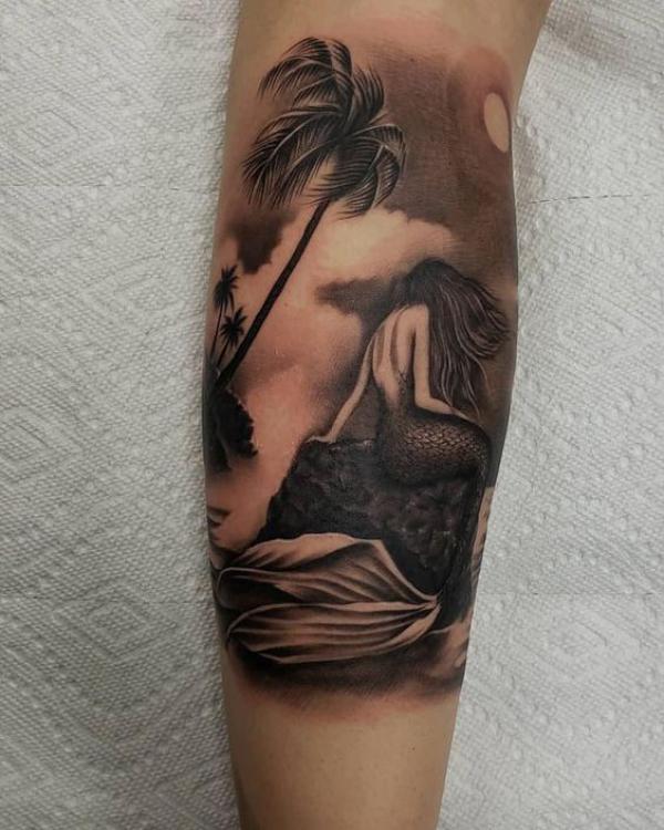 Mermaid and palm tree tattoo in dark theme