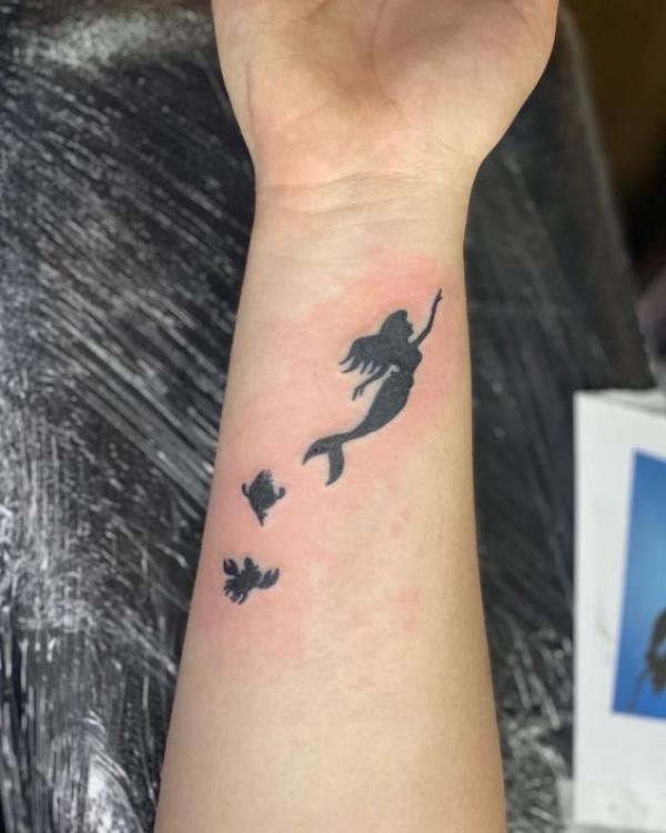 Mermaid silhouette wrist tattoo