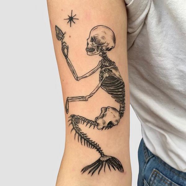 Mermaid skeleton and star tattoo