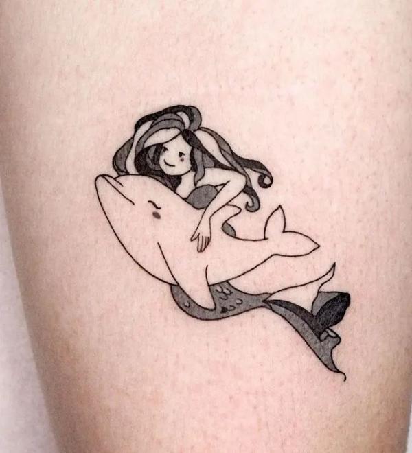 Mermaid swimming with a dolphin tattoo