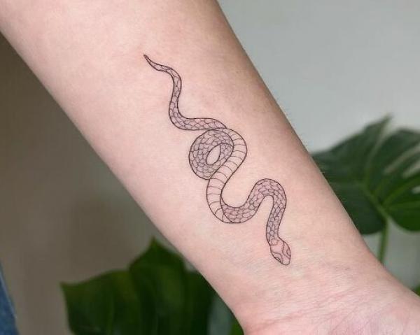 Minimalist snake forearm tattoo