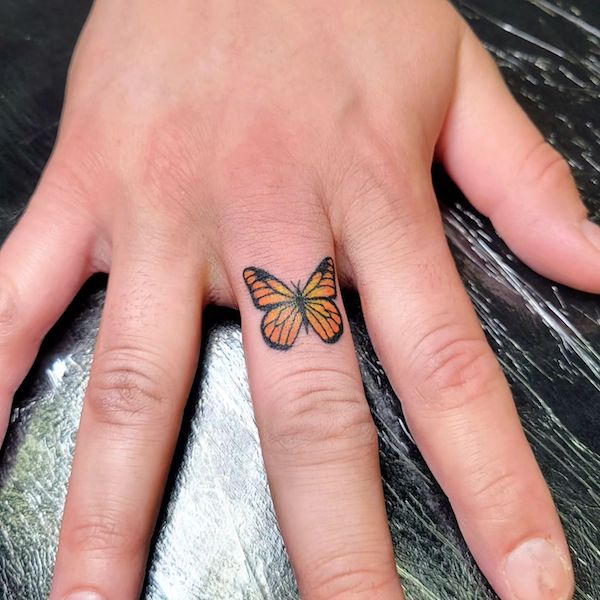 Monarch butterfly finger tattoo