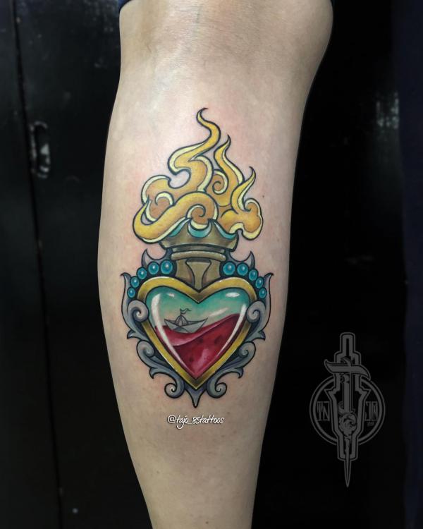 Neo traditional sacred heart tattoo with an origami boat
