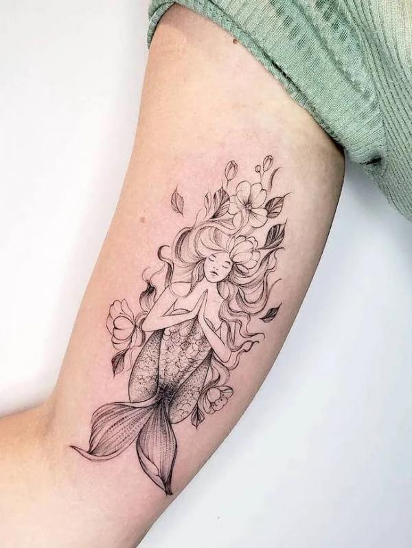 Praying mermaid with flowers tattoo