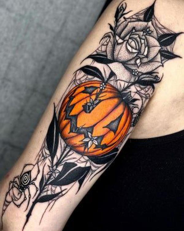 Pumpkin and white roses with spider web