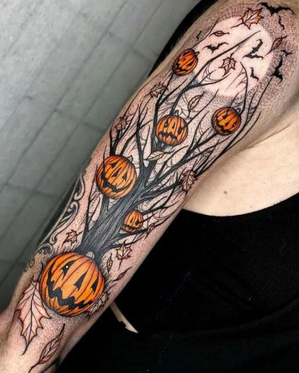 Pumpkins hung on a dead tree under moon